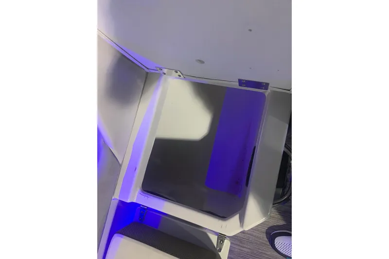 Slide: The Image of 2019 Scarab 255 Wake ID boat storage compartment with blue lighting. - 25