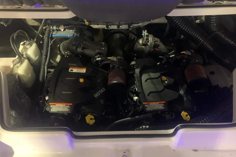 Slide: The Image of Engine compartment of a 2019 Scarab 255 Wake ID boat, featuring dual Rotax engines. - 28