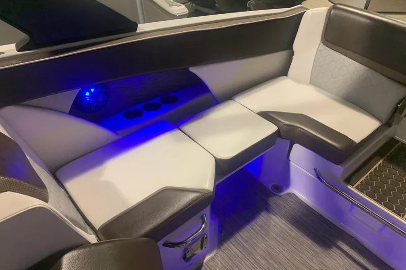 Slide: The Image of 2019 Scarab 255 Wake ID boat interior with cushioned seating and blue LED lighting. - 8