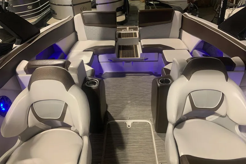 Slide: The Image of Interior of 2019 Scarab 255 Wake ID boat with modern seating and ambient lighting. - 9