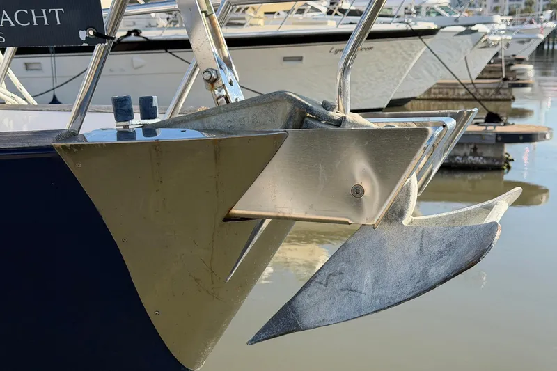 Slide: The Image of Bow of a 2004 Beneteau 57 yacht with anchor, docked in marina. - 11