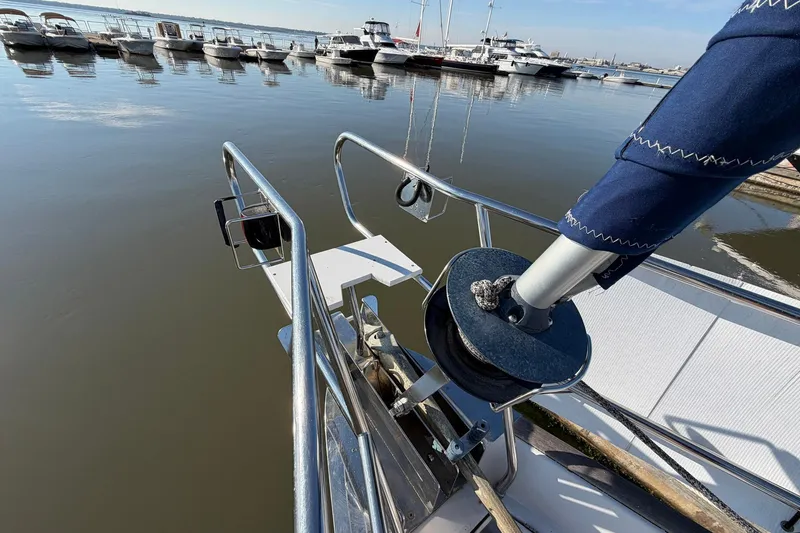 Slide: The Image of Bow of 2004 Beneteau 57 yacht docked at marina with calm waters. - 12