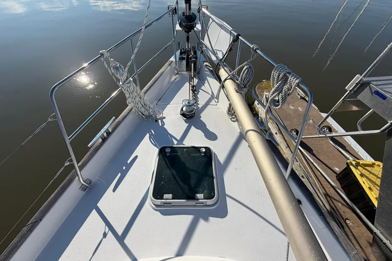 Slide: The Image of Deck view of a 2004 Beneteau 57 sailboat, showing rigging and hatch. - 13