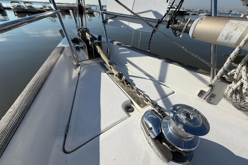 Slide: The Image of Deck of 2004 Beneteau 57 sailboat with anchor chain and winch. - 14