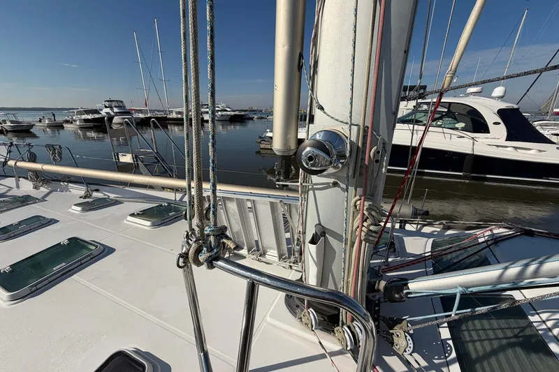 Slide: The Image of 2004 Beneteau 57 sailboat deck with rigging, docked in a marina. - 18