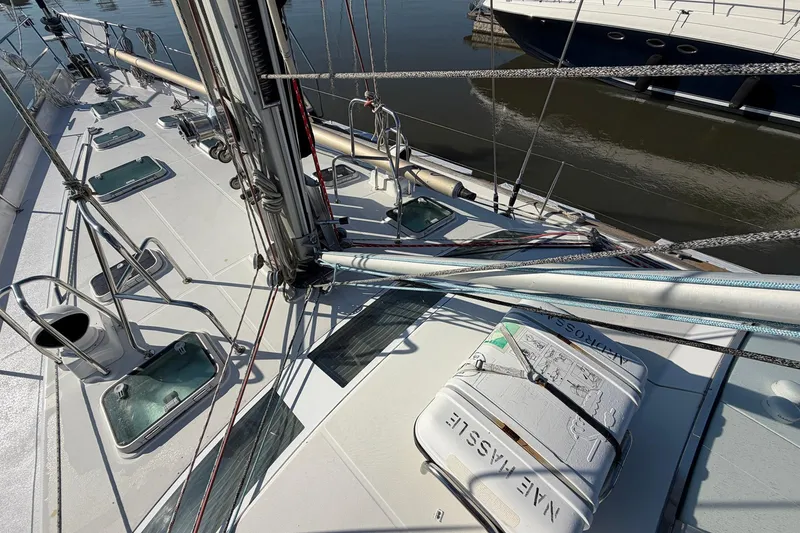 Slide: The Image of Deck view of a 2004 Beneteau 57 sailboat with rigging and hatches. - 19