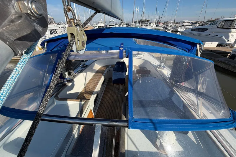 Slide: The Image of 2004 Beneteau 57 sailboat cockpit with blue canopy, docked in marina. - 20