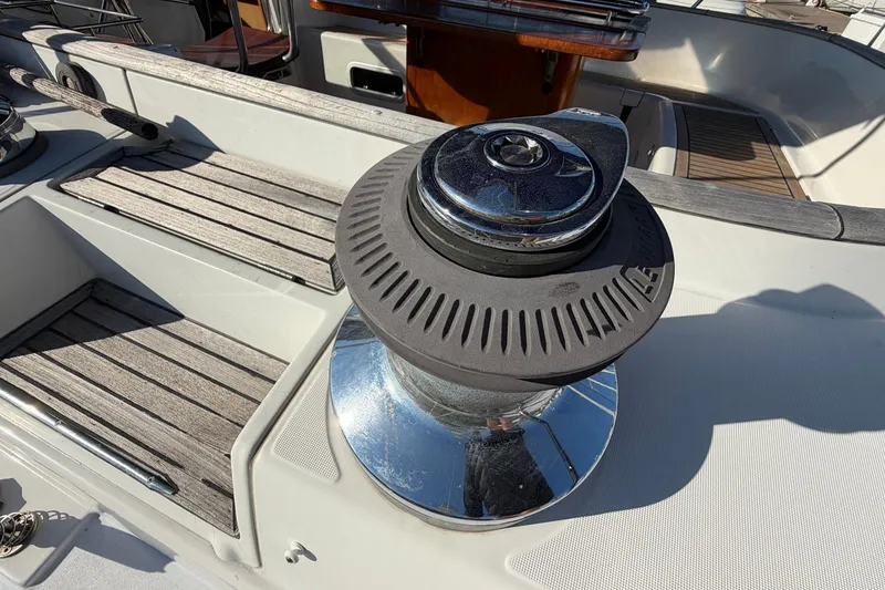 Slide: The Image of Deck of 2004 Beneteau 57 yacht featuring a winch and wooden accents. - 27