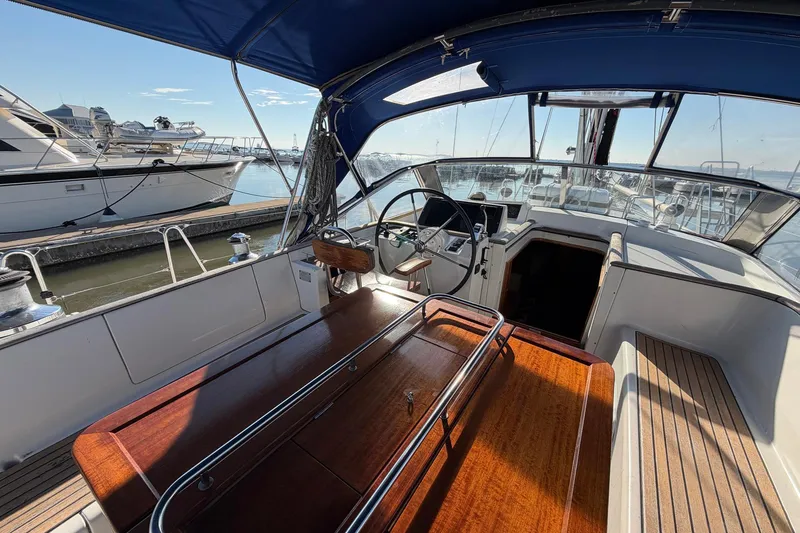 Slide: The Image of Cockpit view of 2004 Beneteau 57 yacht with wooden table and steering wheel. - 29