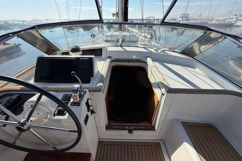 Slide: The Image of Cockpit of 2004 Beneteau 57 yacht with steering wheel and navigation equipment. - 33