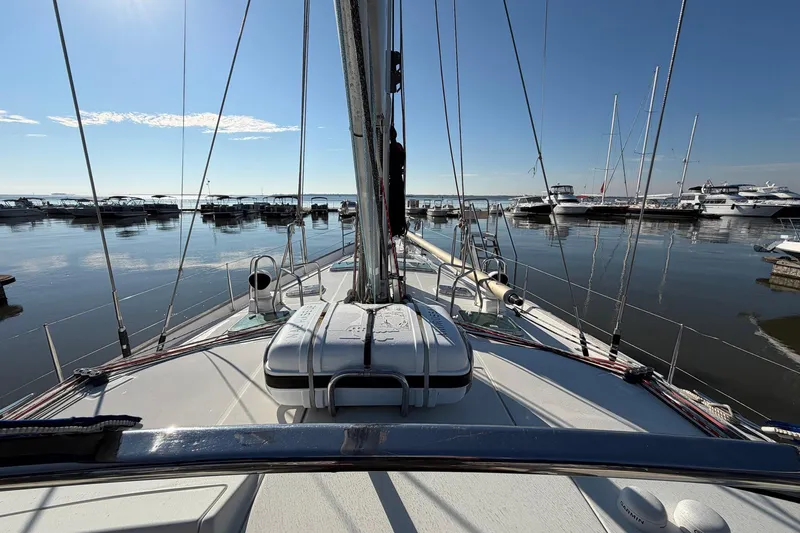 Slide: The Image of 2004 Beneteau 57 sailboat docked in a marina under clear blue skies. - 35
