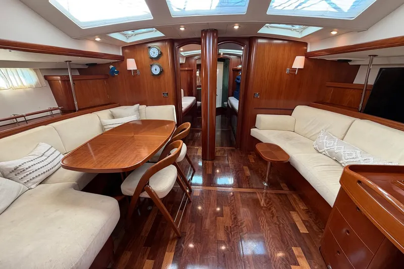 Slide: The Image of Luxurious interior of 2004 Beneteau 57 yacht with elegant wood finish and comfortable seating. - 38