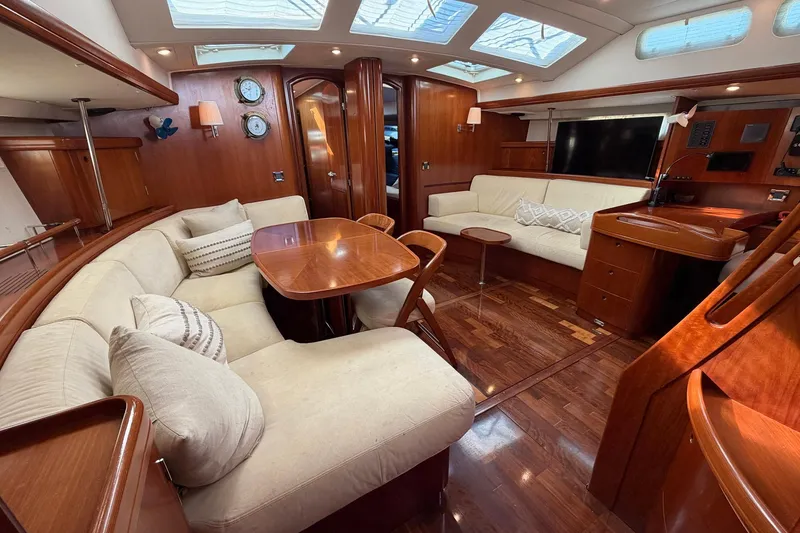 Slide: The Image of Luxurious interior of a 2004 Beneteau 57 yacht with elegant wood finishes and plush seating. - 40