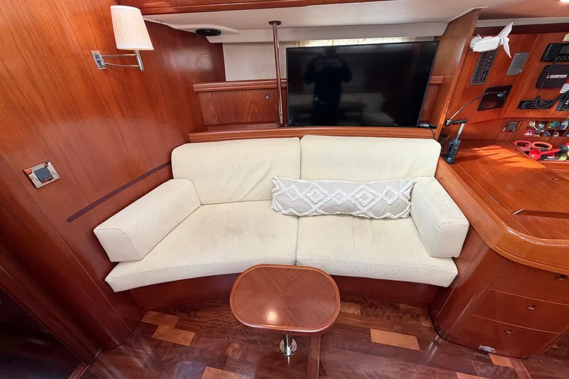 Slide: The Image of Luxurious interior of 2004 Beneteau 57 yacht with cream sofa and wooden accents. - 45