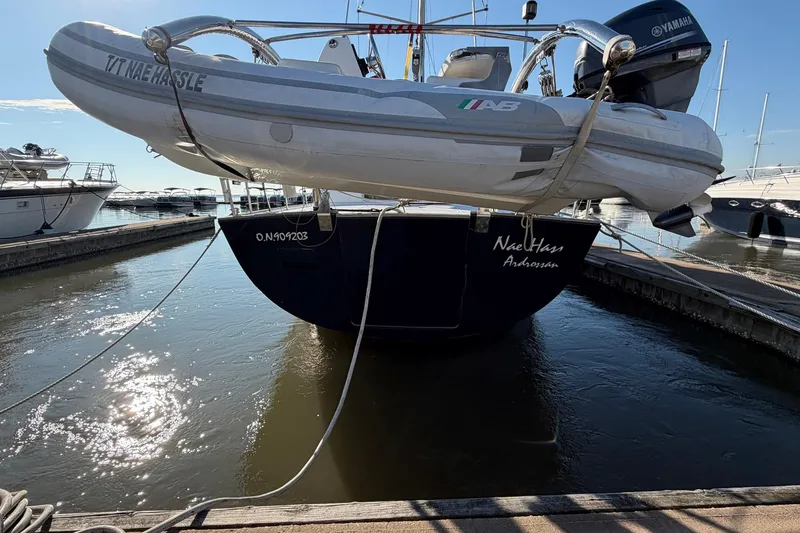 Slide: The Image of Beneteau 57 yacht from 2004 docked with dinghy and Yamaha motor. - 5