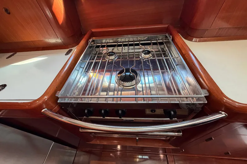 Slide: The Image of Stainless steel stove in 2004 Beneteau 57 yacht kitchen, featuring wooden cabinetry. - 50
