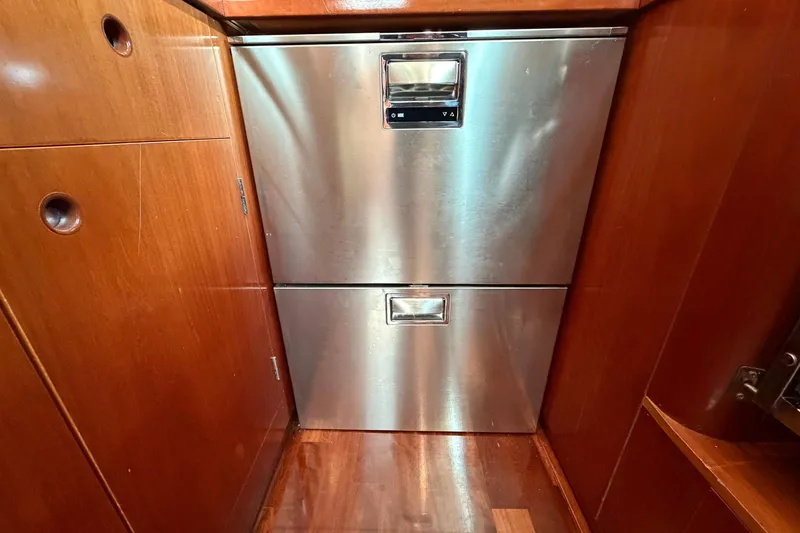 Slide: The Image of Stainless steel drawers in 2004 Beneteau 57 yacht interior, surrounded by wooden cabinetry. - 52