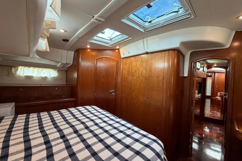 Slide: The Image of Luxurious cabin interior of a 2004 Beneteau 57 yacht with wood finish and skylight. - 56
