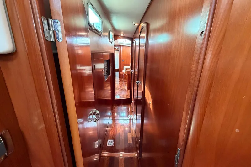 Slide: The Image of Interior hallway of 2004 Beneteau 57 yacht with polished wooden finish. - 63