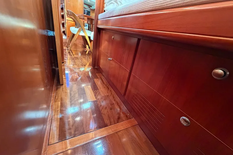 Slide: The Image of Luxurious wooden interior of 2004 Beneteau 57 yacht, featuring polished floors and cabinetry. - 66