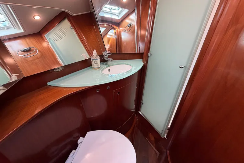 Slide: The Image of Luxurious bathroom in 2004 Beneteau 57 yacht with wood finish and modern fixtures. - 67