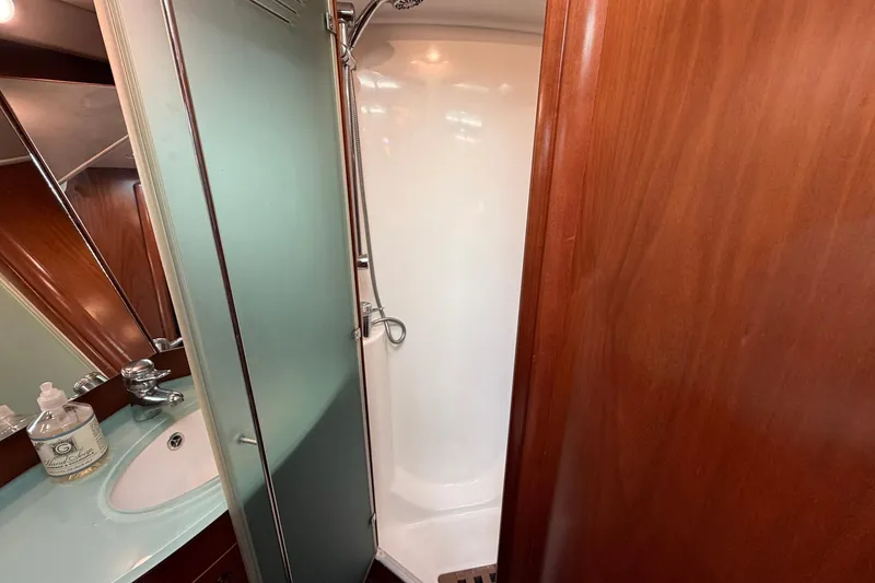 Slide: The Image of Luxurious bathroom in 2004 Beneteau 57 yacht with shower and sink. - 68