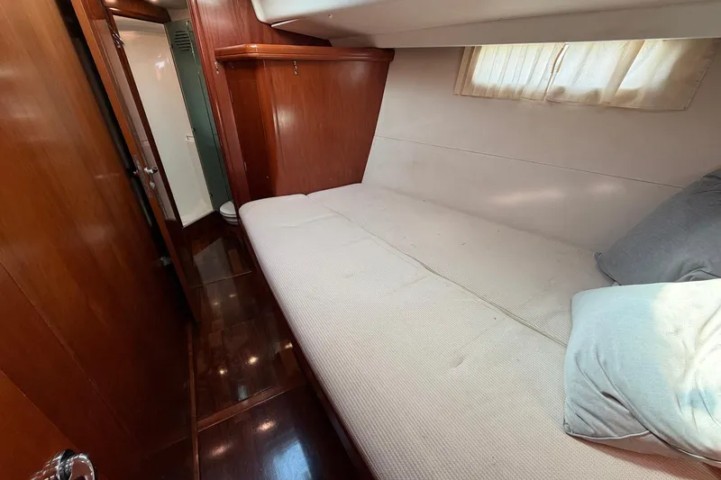 Slide: The Image of Luxurious cabin interior of 2004 Beneteau 57 yacht with cozy bed and wooden finish. - 69
