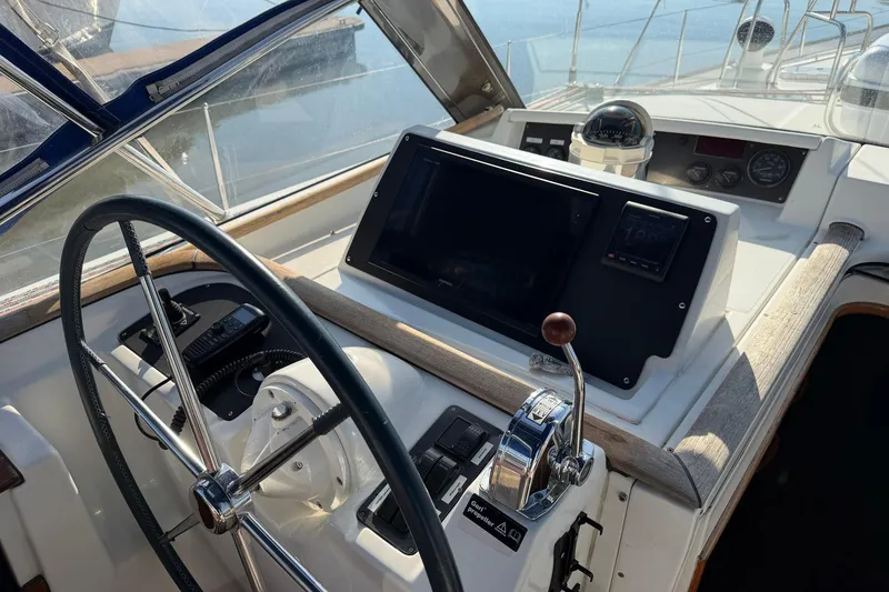 Slide: The Image of Cockpit of 2004 Beneteau 57 sailboat with steering wheel and navigation instruments. - 74
