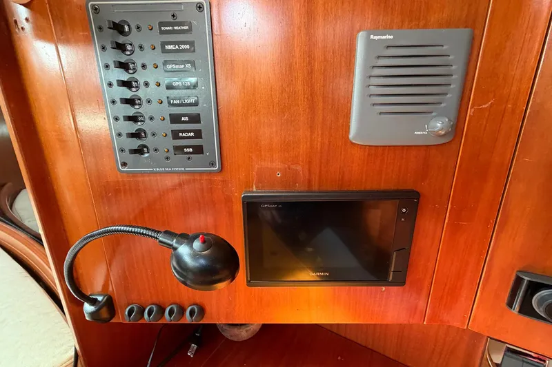 Slide: The Image of Control panel of a 2004 Beneteau 57 yacht with navigation and communication systems. - 76