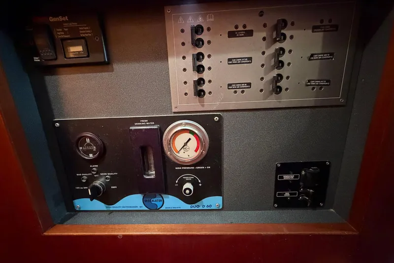 Slide: The Image of Control panel of a 2004 Beneteau 57 yacht, featuring gauges and switches. - 84