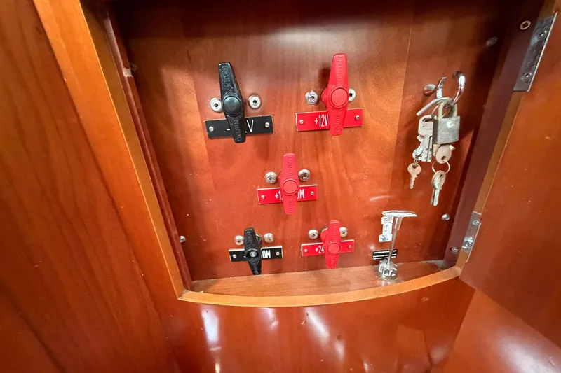 Slide: The Image of Electrical panel with switches and keys inside a 2004 Beneteau 57 yacht. - 86