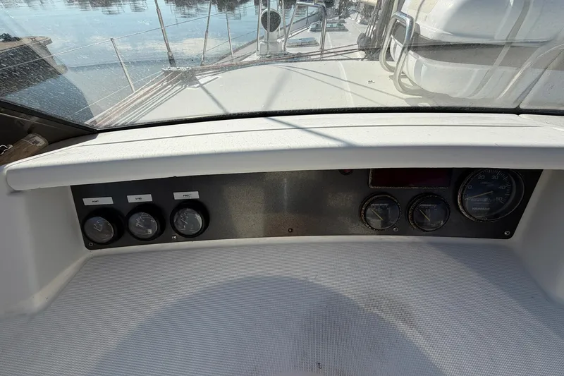 Slide: The Image of Control panel of a 2004 Beneteau 57 yacht, featuring gauges and navigational instruments. - 87
