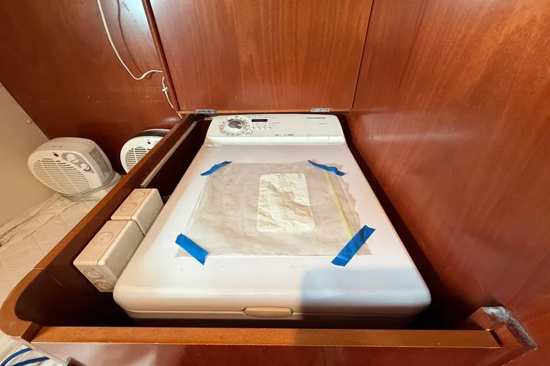 Slide: The Image of Washing machine in a 2004 Beneteau 57 yacht's wooden interior compartment. - 93