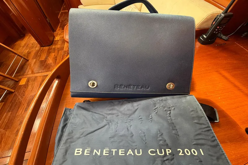 Slide: The Image of Beneteau 57 yacht interior with branded bag and Beneteau Cup 2001 cover. - 94