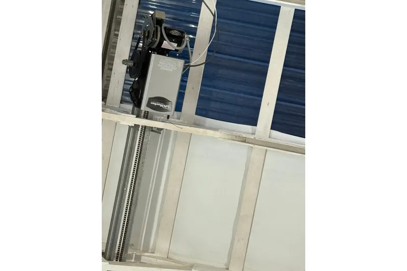 Slide: The Image of Ceiling-mounted LiftMaster garage door opener mechanism. - 15