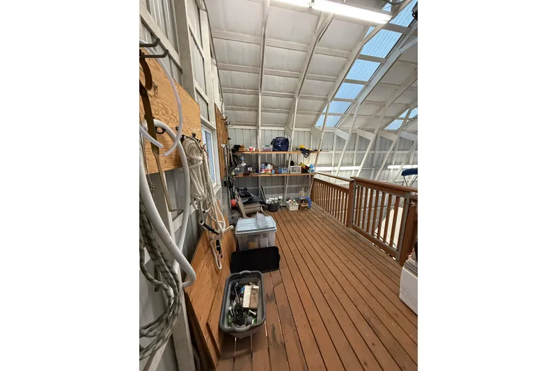 Slide: The Image of Indoor storage area with wooden flooring, shelves, and boating equipment for 1981 Grand Banks 42 Classic. - 16