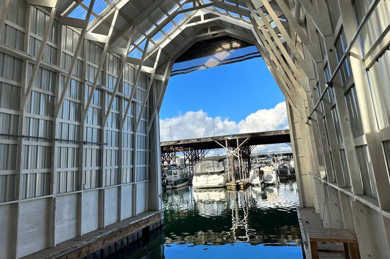 Slide: The Image of Covered marina with boats, featuring a 1981 Grand Banks Classic Tri-cabin. - 2