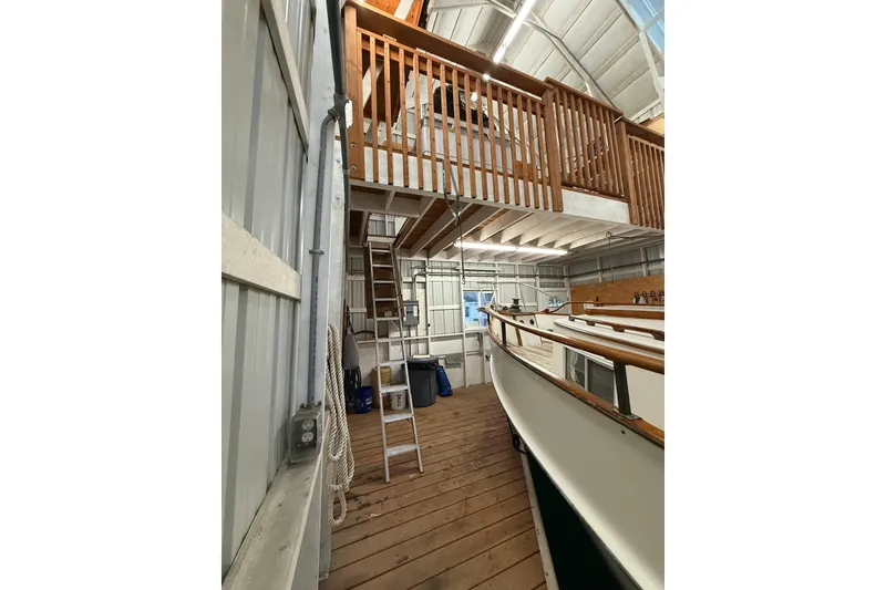 Slide: The Image of 1981 Grand Banks 42 Classic yacht in a wooden boathouse with loft and ladder. - 6