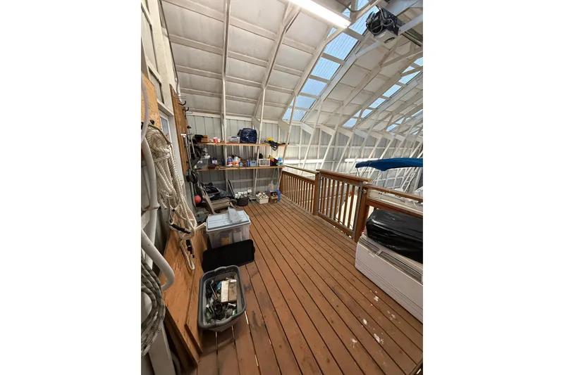 Slide: The Image of Indoor boat storage with wooden deck, shelves, and nautical equipment for 1981 Grand Banks 42 Classic. - 7