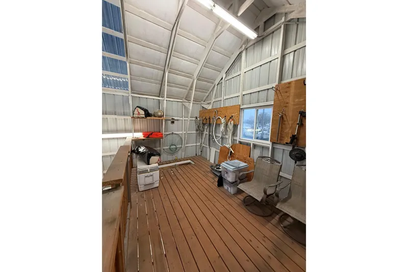 Slide: The Image of Interior of a boathouse with wooden floor, storage shelves, and fishing equipment, related to 1981 Grand Banks 42 Classic. - 8