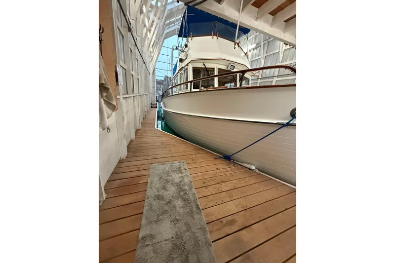 Slide: The Image of 1981 Grand Banks 42 Classic yacht docked in a covered marina. - 18