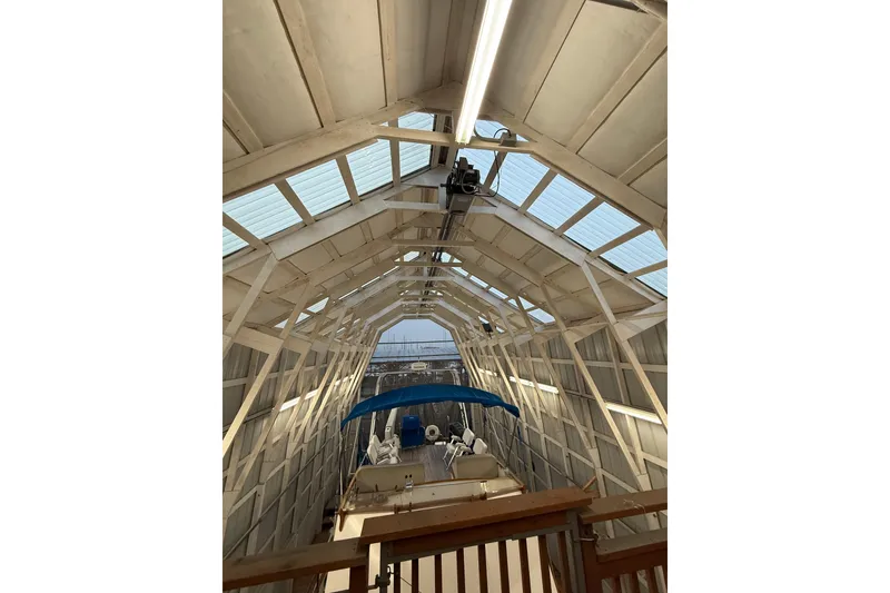 Slide: The Image of 1981 Grand Banks 42 Classic yacht in a covered boathouse with blue canopy. - 5