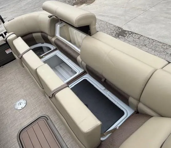 Slide: The Image of 2024 Regency 250 LE3 boat interior with beige seating and storage compartments. - 12