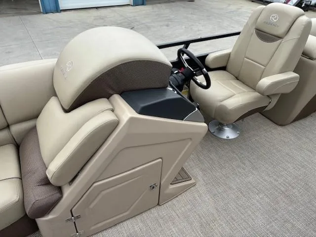 Slide: The Image of 2024 Regency 250 LE3 boat interior with beige seating and steering console. - 22