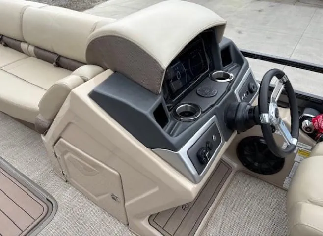 Slide: The Image of 2024 Regency 250 LE3 boat dashboard with steering wheel and control panel. - 23