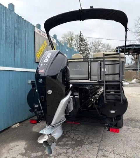 Slide: The Image of 2024 Regency 250 LE3 pontoon boat with powerful 300 V8 engine, parked outdoors. - 6