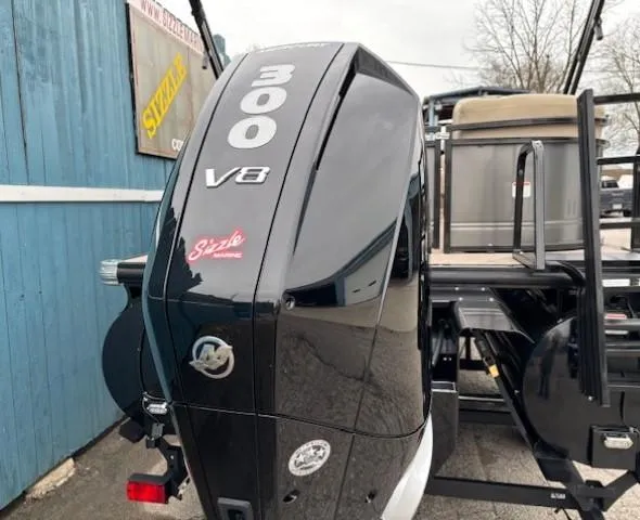 Slide: The Image of 2024 Regency 250 LE3 boat with a powerful 300 V8 engine, docked near a blue wall. - 7