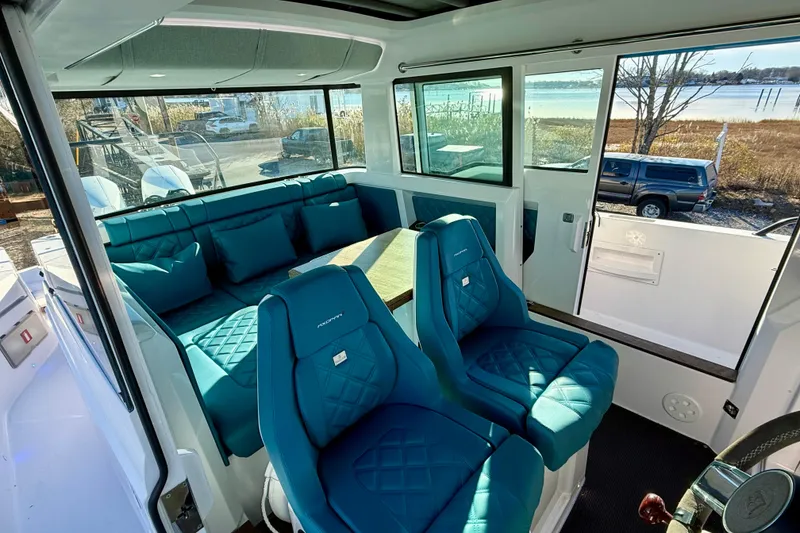Slide: The Image of Luxurious interior of 2021 Axopar 37 XC CROSS CABIN with teal seating and scenic view. - 14
