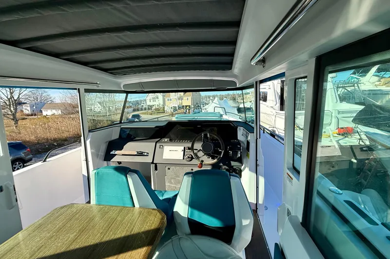 Slide: The Image of Interior view of 2021 Axopar 37 XC CROSS CABIN with modern helm and seating. - 16