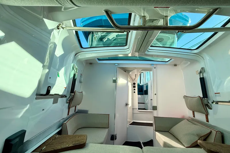 Slide: The Image of Interior of 2021 Axopar 37 XC CROSS CABIN with skylights and modern seating. - 19